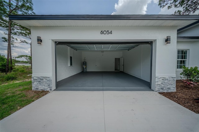 garage featuring concrete driveway