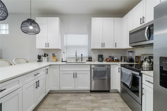 18 S D St, Lake Worth, FL 33460 - kitchen with appliances with stainless steel finishes, a sink, light countertops, and white cabinets