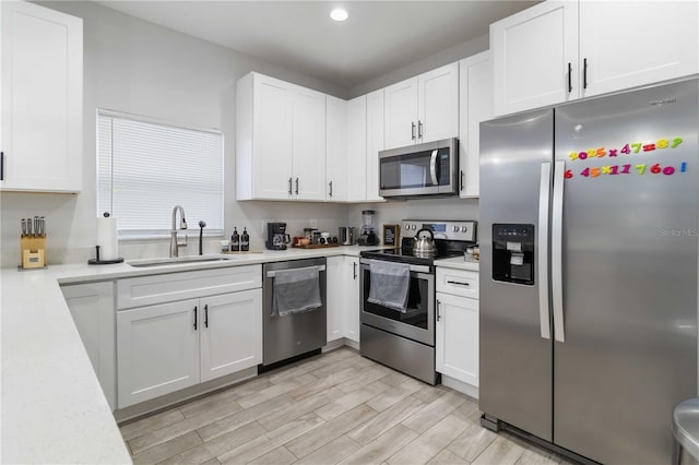 18 S D St, Lake Worth, FL 33460 - kitchen with appliances with stainless steel finishes, a sink, light countertops, white cabinetry, and recessed lighting