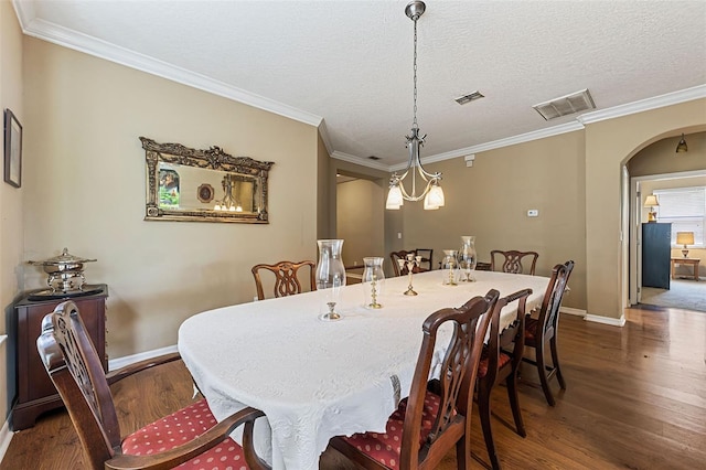 4813 River Gem Ave, Windermere, FL 34786 - dining area featuring dark wood-type flooring, baseboards, arched walkways, ornamental molding, and a textured ceiling