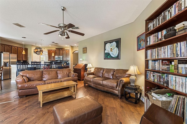 4813 River Gem Ave, Windermere, FL 34786 - living room featuring a ceiling fan, wood finished floors, and a textured ceiling