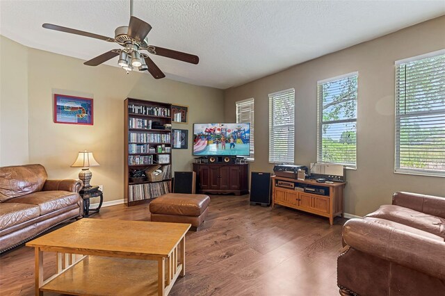 4813 River Gem Ave, Windermere, FL 34786 - living room with wood finished floors, plenty of natural light, ceiling fan, a textured ceiling, and baseboards