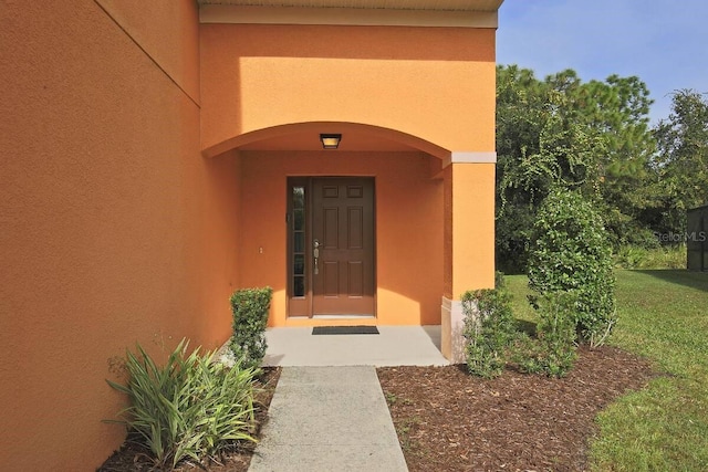 property entrance with stucco siding