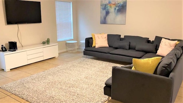 living room featuring light tile patterned floors and baseboards