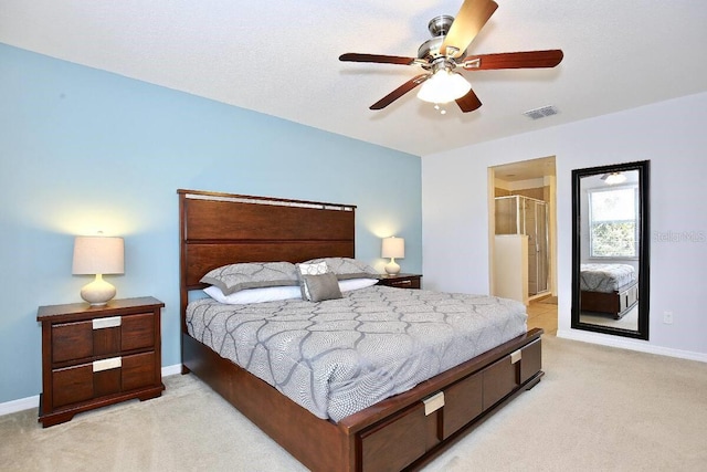 bedroom with light carpet, baseboards, a ceiling fan, and ensuite bathroom