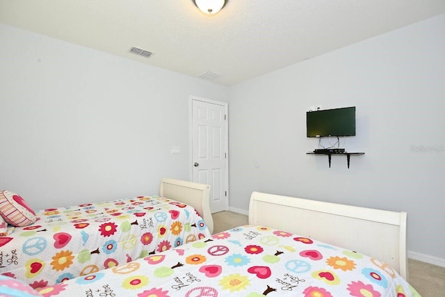 bedroom with light carpet and baseboards