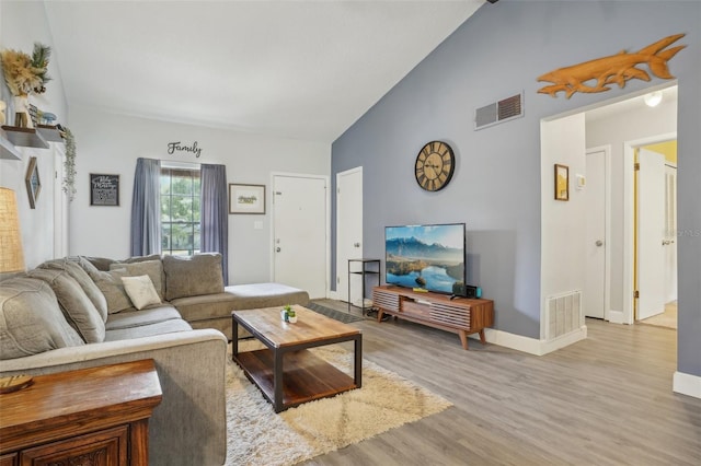 620 Fruitwood Ave, Winter Springs, FL 32708 - living room with wood finished floors, high vaulted ceiling, and baseboards
