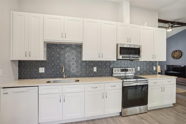 620 Fruitwood Ave, Winter Springs, FL 32708 - kitchen with appliances with stainless steel finishes, a sink, light countertops, and white cabinets