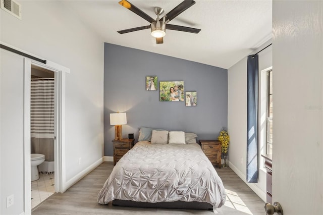 620 Fruitwood Ave, Winter Springs, FL 32708 - bedroom featuring lofted ceiling, light wood-style floors, ensuite bath, baseboards, and ceiling fan