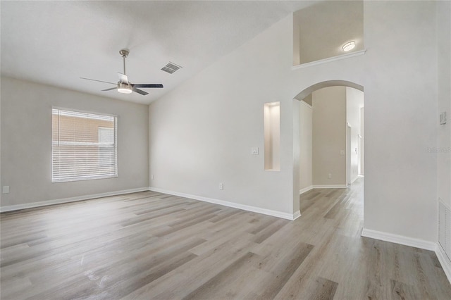 19540 Glen Elm Way, Orlando, FL 32833 - unfurnished room featuring arched walkways, ceiling fan, light wood-style floors, baseboards, and high vaulted ceiling