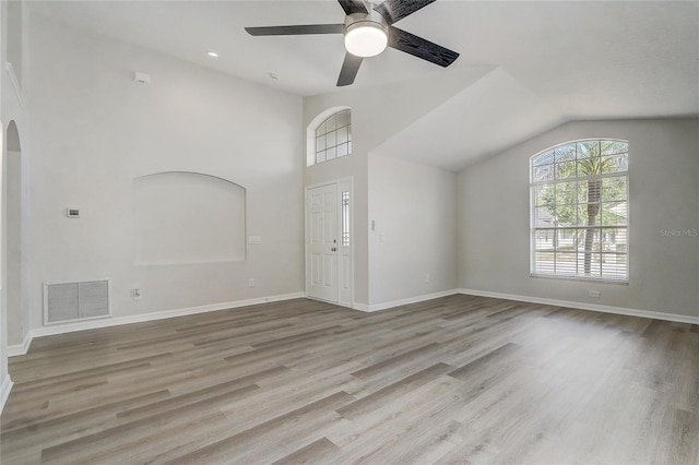 19540 Glen Elm Way, Orlando, FL 32833 - unfurnished living room with arched walkways, ceiling fan, wood finished floors, lofted ceiling, and baseboards