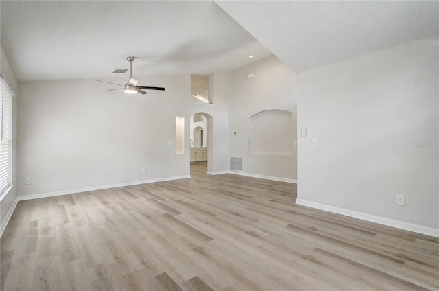 19540 Glen Elm Way, Orlando, FL 32833 - unfurnished living room with arched walkways, a ceiling fan, light wood-style flooring, baseboards, and high vaulted ceiling