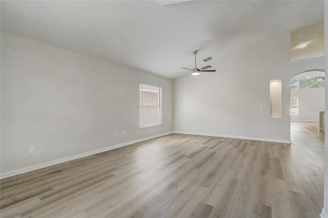 19540 Glen Elm Way, Orlando, FL 32833 - unfurnished room with a ceiling fan, arched walkways, light wood-type flooring, baseboards, and high vaulted ceiling