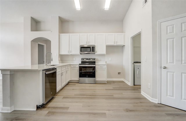 19540 Glen Elm Way, Orlando, FL 32833 - kitchen featuring appliances with stainless steel finishes, a sink, arched walkways, and white cabinets