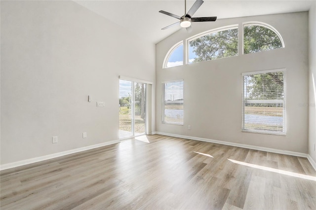 19540 Glen Elm Way, Orlando, FL 32833 - empty room featuring ceiling fan, a high ceiling, light wood finished floors, and baseboards