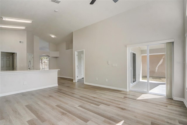 19540 Glen Elm Way, Orlando, FL 32833 - unfurnished living room with high vaulted ceiling, ceiling fan, light wood-style flooring, and baseboards