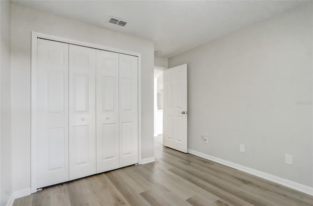 19540 Glen Elm Way, Orlando, FL 32833 - unfurnished bedroom featuring light wood-style flooring, baseboards, and a closet