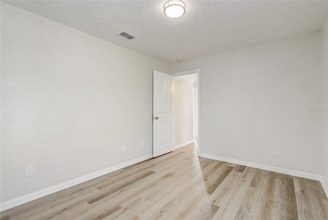 19540 Glen Elm Way, Orlando, FL 32833 - unfurnished room with light wood finished floors, baseboards, and a textured ceiling