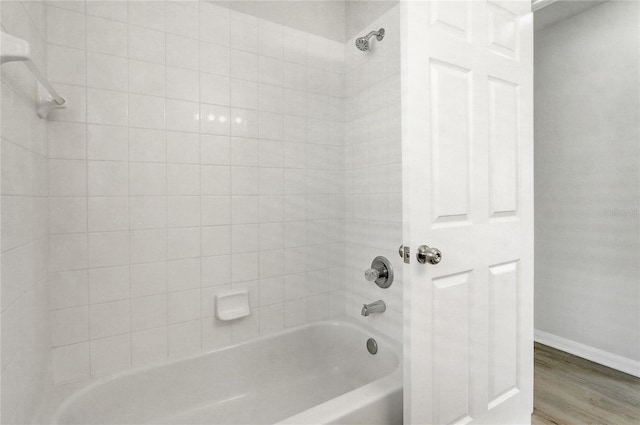 19540 Glen Elm Way, Orlando, FL 32833 - full bathroom with baseboards, wood finished floors, and shower / bath combination