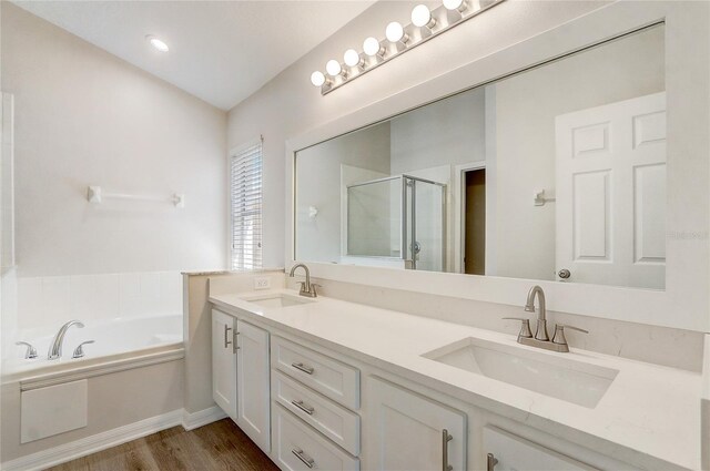 19540 Glen Elm Way, Orlando, FL 32833 - bathroom with a shower stall, wood finished floors, a garden tub, and double vanity