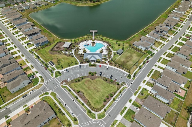 view of property location with a pool area and a nearby body of water