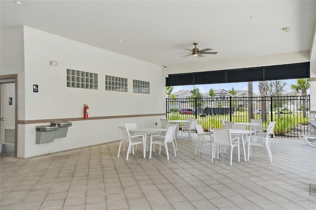 view of patio / terrace with outdoor dining area, a ceiling fan, and fence