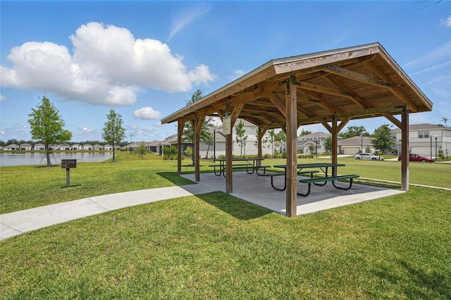 view of home's community with a gazebo, a yard, and a water view
