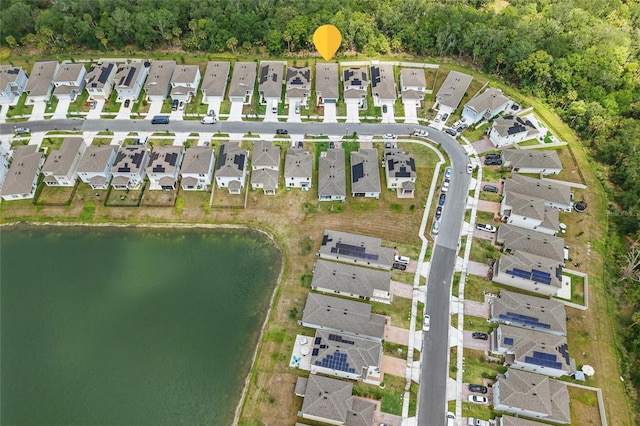 aerial overview of property's location featuring nearby suburban area and a nearby body of water