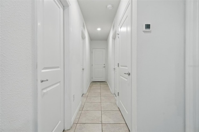corridor featuring light tile patterned floors and recessed lighting