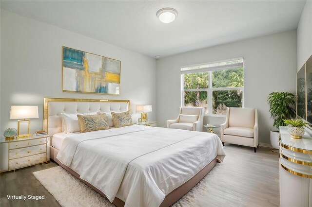 bedroom featuring wood finished floors and baseboards