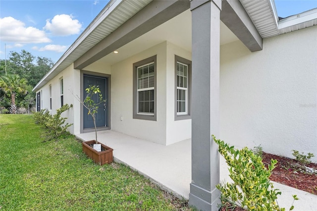 view of home's exterior featuring stucco siding and a yard