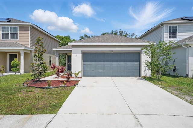 view of front facade with an attached garage, concrete driveway, a front lawn, stucco siding, and roof with shingles