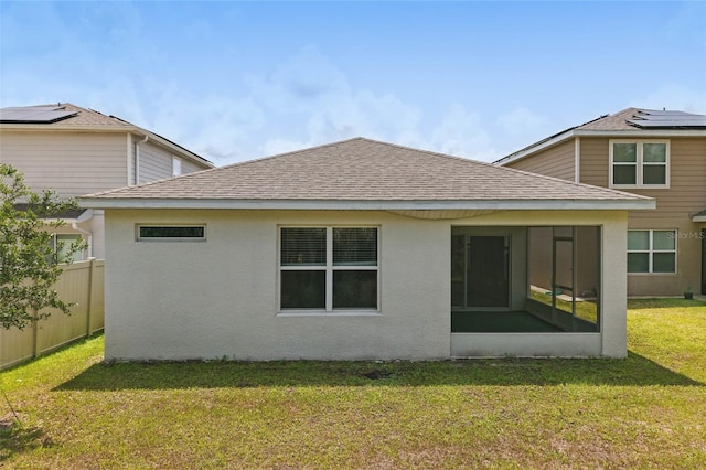 rear view of property featuring a shingled roof, a sunroom, and stucco siding