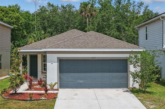view of front facade with roof with shingles, driveway, stucco siding, and an attached garage