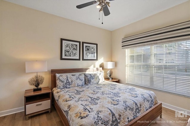 8941 Bismarck Palm Rd, Kissimmee, FL 34747 - bedroom with baseboards, wood finished floors, and ceiling fan