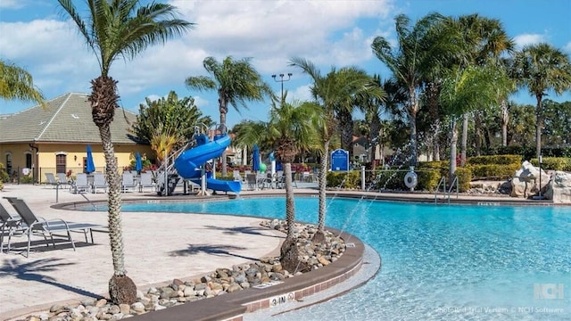 8941 Bismarck Palm Rd, Kissimmee, FL 34747 - community pool with a water slide and a patio area