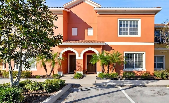 8941 Bismarck Palm Rd, Kissimmee, FL 34747 - view of front of home featuring stucco siding, uncovered parking, and a tiled roof