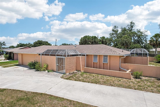 1301 Lucaya Ave, Venice, FL 34285 - view of front of house featuring concrete driveway, an attached garage, and stucco siding