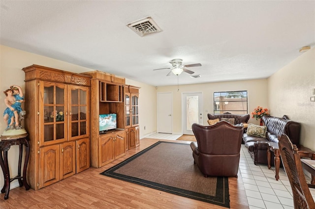 1301 Lucaya Ave, Venice, FL 34285 - living area with ceiling fan, light wood-style flooring, and a textured ceiling