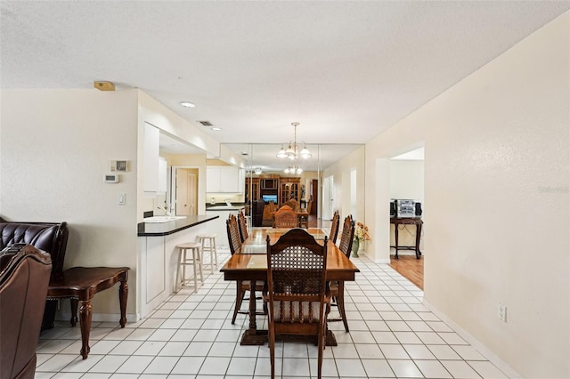 1301 Lucaya Ave, Venice, FL 34285 - dining room with a chandelier, baseboards, and light tile patterned flooring