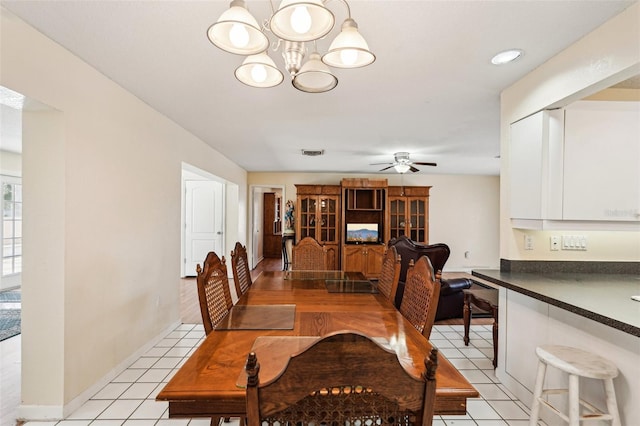 1301 Lucaya Ave, Venice, FL 34285 - dining area featuring a ceiling fan, a chandelier, and light tile patterned floors