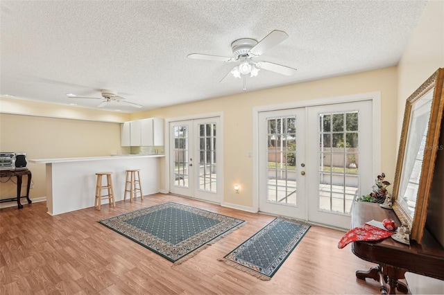 1301 Lucaya Ave, Venice, FL 34285 - entryway featuring french doors, ceiling fan, a textured ceiling, wood finished floors, and baseboards