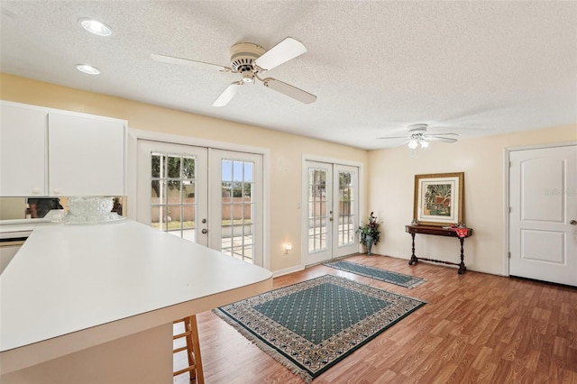 1301 Lucaya Ave, Venice, FL 34285 - living room featuring french doors, ceiling fan, a textured ceiling, and light wood-style flooring