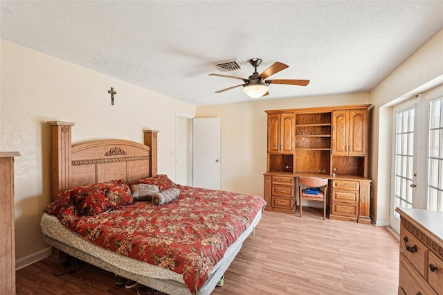 1301 Lucaya Ave, Venice, FL 34285 - bedroom featuring light wood finished floors, a textured ceiling, baseboards, and ceiling fan