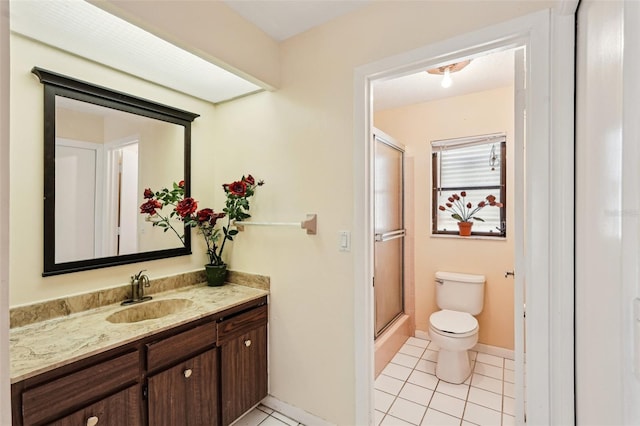 1301 Lucaya Ave, Venice, FL 34285 - full bath with toilet, an enclosed shower, tile patterned floors, vanity, and baseboards
