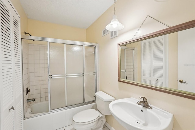 1301 Lucaya Ave, Venice, FL 34285 - bathroom featuring a closet, a sink, toilet, and enclosed tub / shower combo