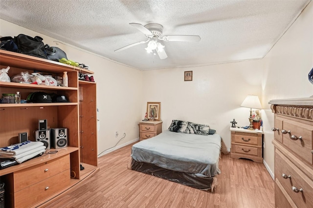1301 Lucaya Ave, Venice, FL 34285 - bedroom with light wood-style floors, a textured ceiling, an office area, ceiling fan, and baseboards