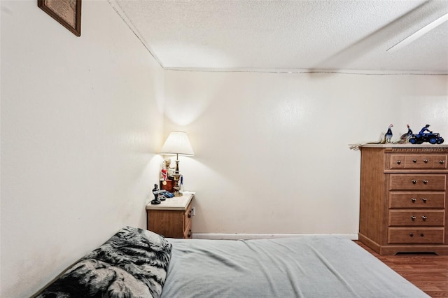 1301 Lucaya Ave, Venice, FL 34285 - bedroom featuring wood finished floors and a textured ceiling