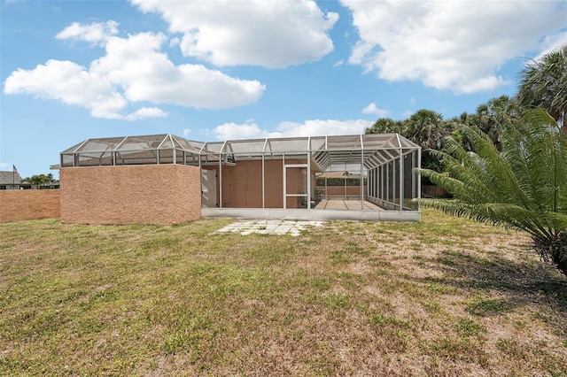 1301 Lucaya Ave, Venice, FL 34285 - view of grassy yard with glass enclosure and a patio area