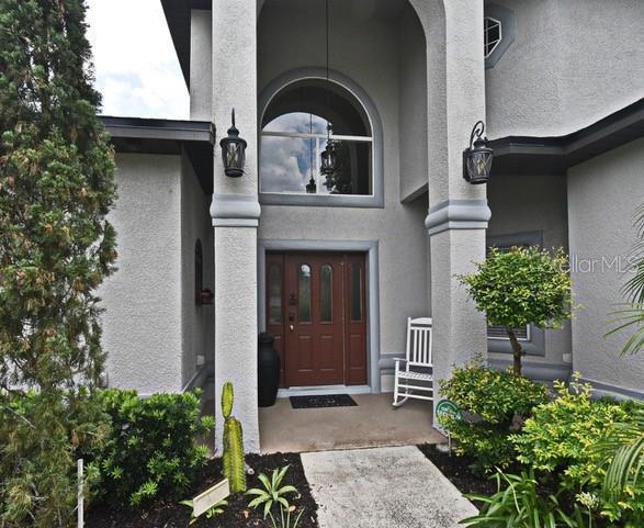 doorway to property featuring stucco siding